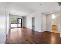 Spacious living room features hardwood floors and access to a balcony with views of palm trees at 353 E Bonneville Ave # 375, Las Vegas, NV 89101