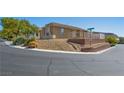 A corner lot home is terraced with gravel and minimal desert foliage for low maintenance at 4016 Balsam Mountain St, Las Vegas, NV 89129