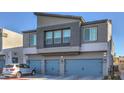 Modern two-story home showcasing a gray exterior and a three-car garage with driveway at 4278 Lemay St # 2, Las Vegas, NV 89115