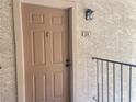 Close-up of the entry door, showing the unit number and traditional door hardware at 4370 Sandy River Dr # 24, Las Vegas, NV 89103