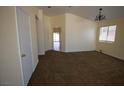 Bright living room with neutral walls and carpets, archway entrance and ample natural light at 5200 Brookmere Dr, Las Vegas, NV 89130