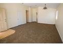 Spacious living room with neutral carpet, high ceilings, and lots of natural light at 5200 Brookmere Dr, Las Vegas, NV 89130