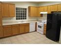 Bright kitchen features light wood cabinets, white appliances and ample counter space at 5481 Railroad River Ave, Las Vegas, NV 89139