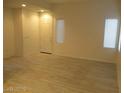 Open living room with light wood floors and windows provides ample natural light at 5481 Railroad River Ave, Las Vegas, NV 89139