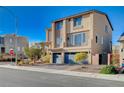 A modern two-story home with desert landscaping, three car garage, and neutral color palette at 5946 Ancient Peaks Ave, Las Vegas, NV 89141