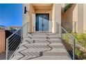 Close up on a blue double-door entry with steel railing and concrete stairs at 5946 Ancient Peaks Ave, Las Vegas, NV 89141
