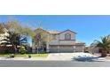 Spacious two-story home with a three-car garage, landscaped front yard, and a well-maintained lawn at 6915 Cedar Basin Ave, Las Vegas, NV 89142