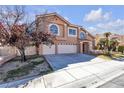 Attractive two-story home with a three-car garage, landscaped yard, and a sidewalk view at 7425 Enchanted Hills Ct, Las Vegas, NV 89129