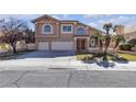 Inviting two-story home with a three-car garage, palm trees, and a neatly kept front yard at 7425 Enchanted Hills Ct, Las Vegas, NV 89129
