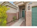 Inviting entryway featuring a covered porch with decorative lantern and address number at 7690 Blue Whirlpool St, Las Vegas, NV 89131