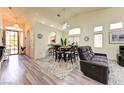 Open-concept living area with vaulted ceilings, modern flooring, and abundant natural light at 9677 Emeraude Ave, Las Vegas, NV 89147