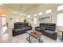 Spacious living area with comfortable seating, neutral tones, and an open floor plan at 9677 Emeraude Ave, Las Vegas, NV 89147