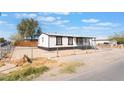 Well-maintained single-story home with a quaint front porch and fenced yard, ideal for serene living at , Las Vegas, NV 89156