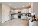 Bright kitchen featuring granite countertops, stainless steel appliances, and white cabinets with ample storage space at 4454 Lantern Point Ave, North Las Vegas, NV 89084