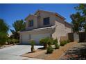 Attractive two-story home with a two-car garage, complemented by landscaping and a walkway leading to the entrance at 10417 Niagara Falls Ln, Las Vegas, NV 89144