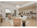 An open floor plan living room area flows into a kitchen and a view of an outdoor seating area at 11700 Belorado Ave, Las Vegas, NV 89138