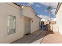 Side exterior view of house with desert landscaping and security door on entry at 1813 Villa Vista Way, Las Vegas, NV 89128