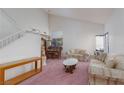 Bright living room featuring high ceilings, staircase, plush carpet, and neutral walls at 1813 Villa Vista Way, Las Vegas, NV 89128
