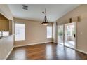 Bright dining room features wood floors, large windows and sliding glass door leading to the patio at 2175 Point Mallard Dr, Henderson, NV 89012