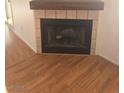 Close-up of the fireplace with tiled surround and laminate flooring at 2232 Aspen Mirror Way # 204, Laughlin, NV 89029