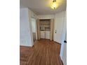 Hallway featuring a laundry closet and wood-look flooring, illuminated by a ceiling light fixture at 2232 Aspen Mirror Way # 204, Laughlin, NV 89029