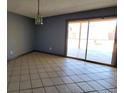 A spacious room with tile flooring leading to a sliding glass door at 3105 Palo Verde Dr, Laughlin, NV 89029