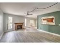 Bright living room featuring a fireplace, ceiling fan, and a view into the kitchen through an arched opening at 3411 Sunfish Dr # B, Henderson, NV 89014