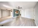 Open living area with wood-look floors, ceiling fan, view to kitchen, and plenty of natural light at 3411 Sunfish Dr # B, Henderson, NV 89014
