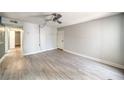Spacious living room showcasing wood-look floors, a ceiling fan, neutral paint, and a hallway view at 3411 Sunfish Dr # B, Henderson, NV 89014