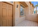 Welcoming front entry featuring a tiled patio and a well-lit, covered doorway at 3426 Dry Gulch Dr, Laughlin, NV 89029