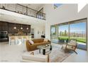 Bright, open-concept living space featuring high ceilings, modern furniture, and sliding glass doors to the backyard at 350 Gandara St, Las Vegas, NV 89138
