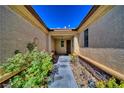Covered entryway leading to the front door, enhanced by lush green landscaping at 3854 E Chaffe Ave, Pahrump, NV 89061