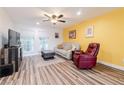 Bright living room with updated flooring, neutral sofa, and natural light at 3949 S Torrey Pines Dr, Las Vegas, NV 89103