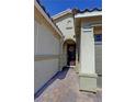 Charming covered entry features brick pavers and a welcoming front door with seasonal wreath at 4680 Suntree Ct, Pahrump, NV 89061