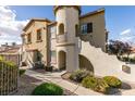 Inviting exterior of a townhome with a private entrance, featuring well-maintained landscaping and walkway at 50 Aura De Blanco St # 19203, Henderson, NV 89074