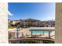 Community pool area with lounge chairs surrounded by well-maintained landscaping and residential buildings at 50 Aura De Blanco St # 19203, Henderson, NV 89074