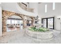 Spacious foyer with stone archways, a decorative fountain, soaring ceilings, and elegant tile flooring at 503 Aaron Way, Boulder City, NV 89005