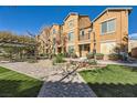 Home's exterior featuring landscaping, a balcony, and a pergola-covered seating area with picnic benches at 5179 Silica Chalk Ave, Las Vegas, NV 89115