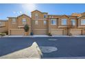 Exterior shot showcasing modern townhomes with attached garages along a clean, quiet street at 5179 Silica Chalk Ave, Las Vegas, NV 89115