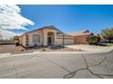 Single-story home featuring a spacious driveway, desert landscaping, and a three-car garage at 5419 Sharpei Ct, Las Vegas, NV 89131