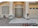 Elegant front entrance with a secure metal gate, decorative accents, and a cozy bench at 5419 Sharpei Ct, Las Vegas, NV 89131