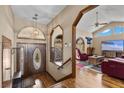 Elegant entryway with wood floors, staircase and a living room view at 5690 N Park St, Las Vegas, NV 89149