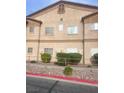 Traditional multi-Gathering building showing a tan stucco exterior, complemented by manicured landscaping and mature shrubbery at 5751 E Hacienda Ave # 159, Las Vegas, NV 89122