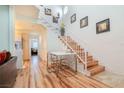 Bright dining area with modern table set, wooden stairs, and stylish decor at 5771 Ritter Ln, Las Vegas, NV 89118