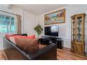 Comfortable living room with a large TV, artwork, and stylish display cabinet at 5771 Ritter Ln, Las Vegas, NV 89118