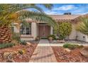 Inviting front entrance with brick pathway and manicured landscaping for curb appeal at 6405 Break Point Ave, Las Vegas, NV 89130