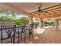 Relaxing outdoor bar area with tile flooring, ceiling fans, and seating for entertaining at 6405 Break Point Ave, Las Vegas, NV 89130