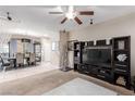 Inviting living room featuring tile and carpet flooring, complemented by natural light and an open concept layout at 6476 Little Harbor Ct, Las Vegas, NV 89141
