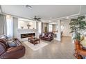 Bright living room with a fireplace, tile floors, and stylish leather furniture at 6484 Mount Eden Ave, Las Vegas, NV 89139
