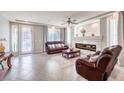 Inviting living room featuring a fireplace, tile floors, and leather furniture at 6484 Mount Eden Ave, Las Vegas, NV 89139